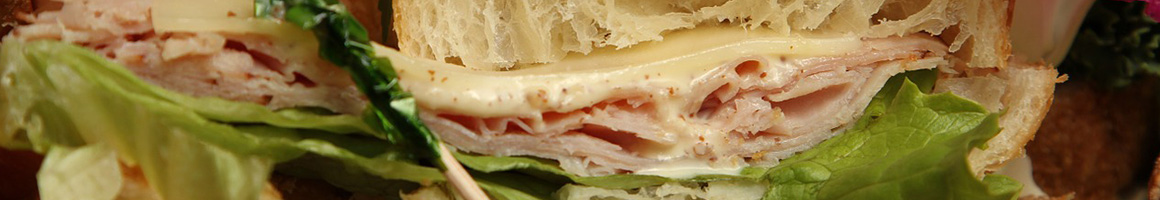 Eating Deli Sandwich at Village Bagels Connecticut restaurant in Norwalk, CT.